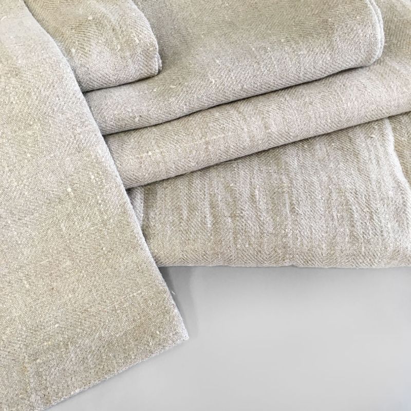 A stack of Donatas Modern, Eco friendly Linen Bath Towels in beige