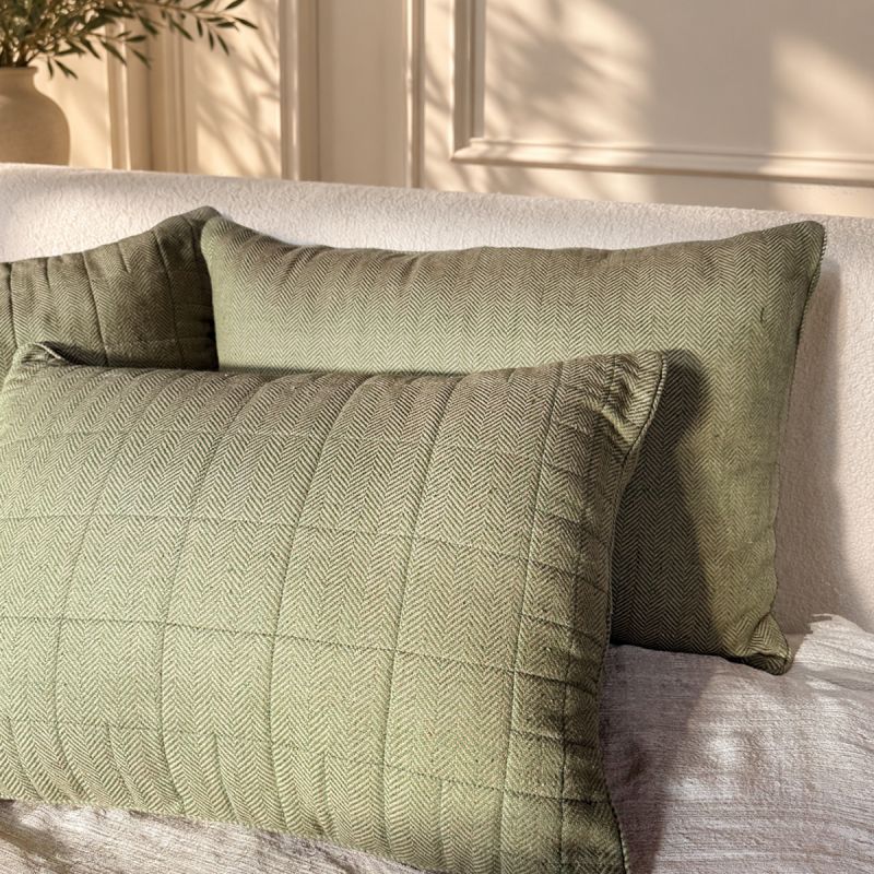 Herringbone hand-loomed silk decorative pillows in muted green with a distinctive woven V-shaped pattern